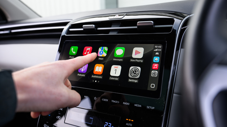Driver Using Apple CarPlay on Touchscreen
