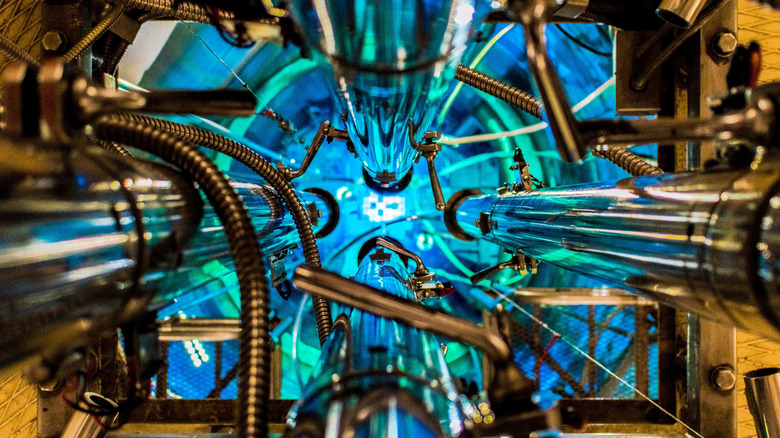 A top down image of the rods of the RA-3 Research and Production Reactor of the National Atomic Energy Commission in Argentina glow bright blue.