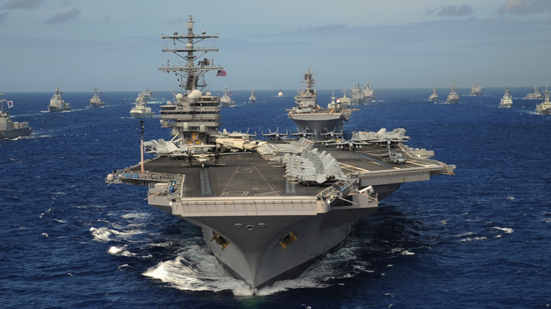 aircraft carrier at sea leading a formation of ships