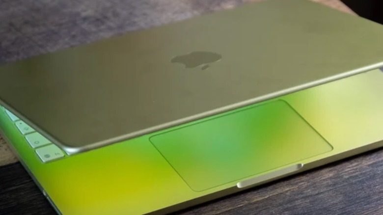 A close-up shot of a half-opened MacBook Neo