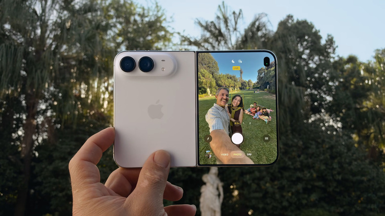 iPhone Duo being held open in a hand outdoors