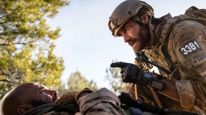 Jake Gyllenhaal pointing at Dar Salim who is lying on the ground in The Covenant