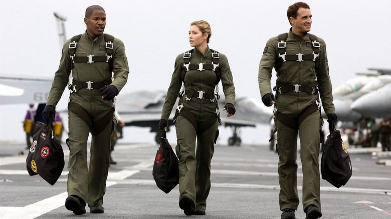 Purcell (Jamie Foxx), Wade (Jessica Biel), and Gannon (Josh Lucas) walking together on the USS Abraham Lincoln