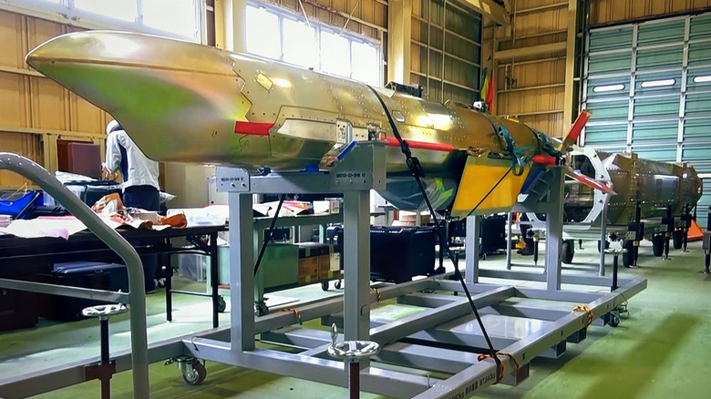 Japan's New SSM missile resting on stand in laboratory.