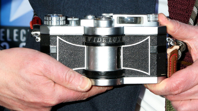 Someone holding an original Widelux camera.