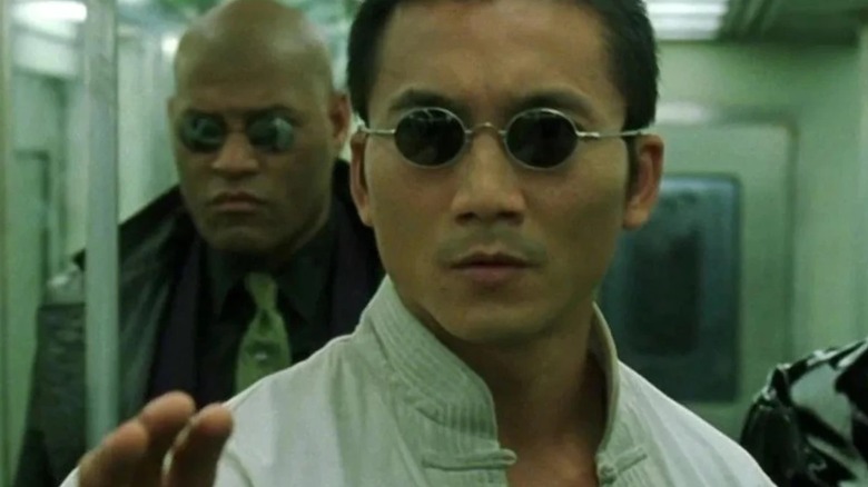 Collin Chou as Seraph stood in front of Morpheus in The Matrix Reloaded