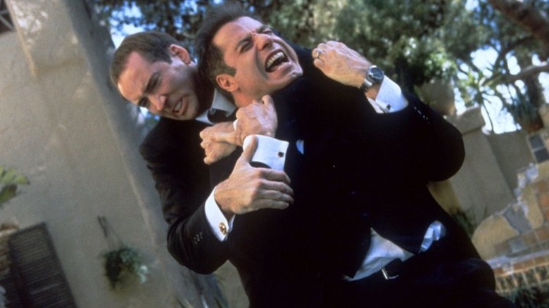 Nicolas Cage strangling John Travolta in Face/Off