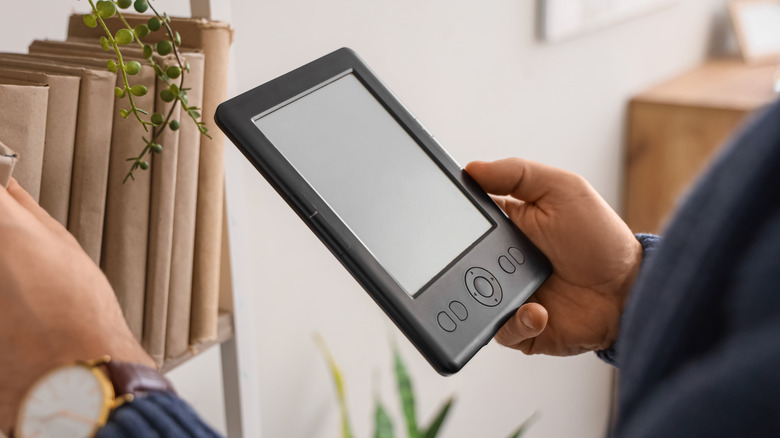 Close-up of a hand holding an e-reader