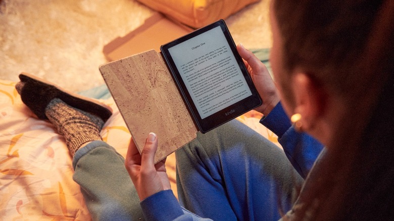 Woman reading a Kindle with a flip screen