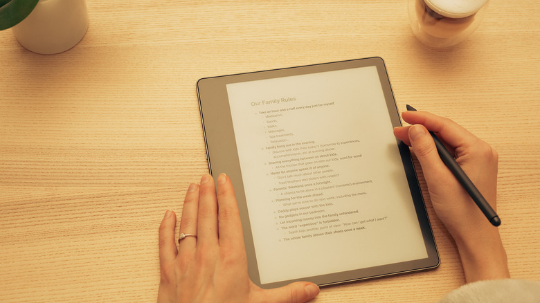 A woman reading a document on a Kindle Scribe
