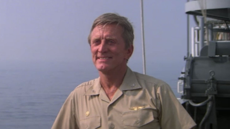 Captain Matthew Yelland (Kirk Douglas) standing on a boat in "The Final Countdown."