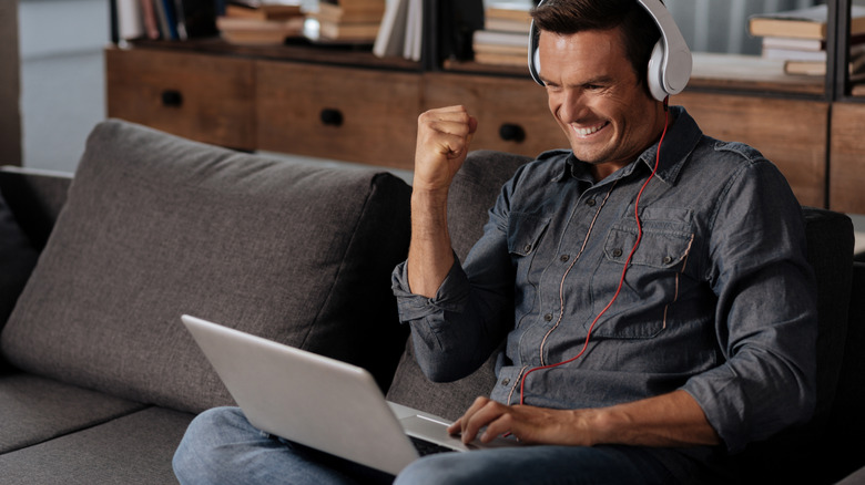 Person playing video games on laptop
