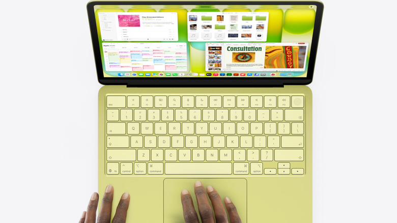 Yellow MacBook Neo with lid open on white background