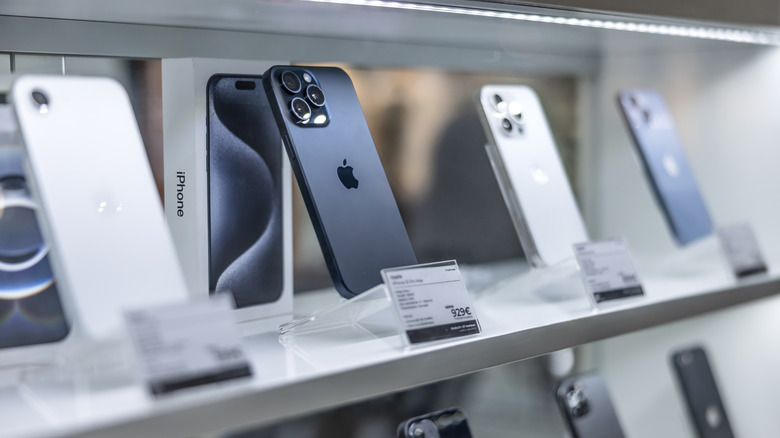 iPhones on display in a store with a focus on the camera.