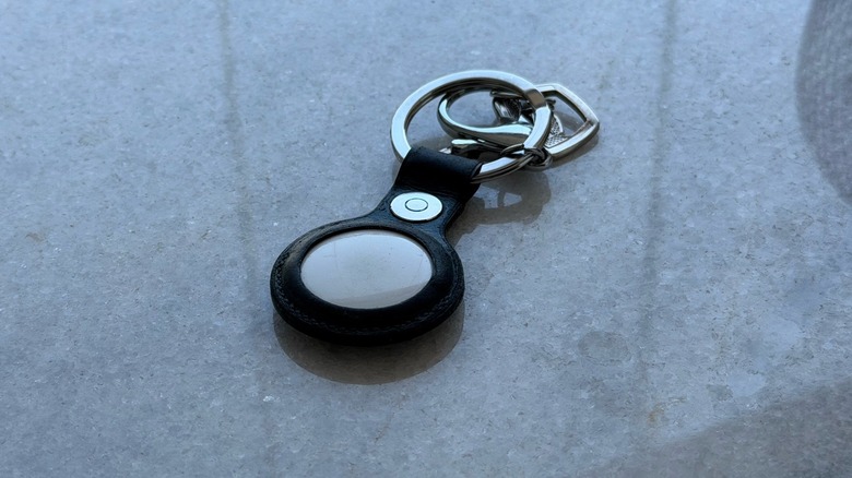 Apple's first-gen AirTag keychain on a countertop