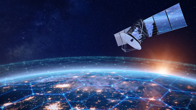 A satellite floating in orbit above a large connected network