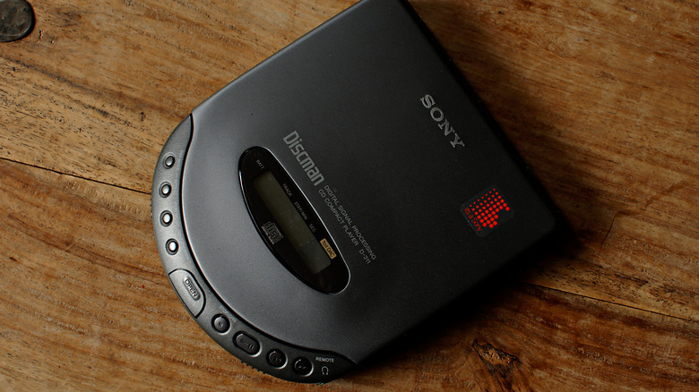 A top-down view of a black Sony Discman on a wooden tabletop.
