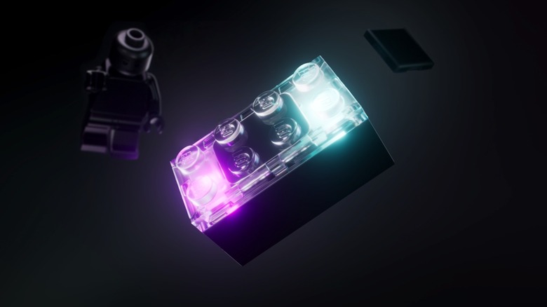 A Lego Smart Brick in the foreground, with a minifig and tag seen in the background