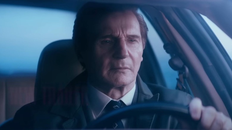 Liam Neeson driving a car