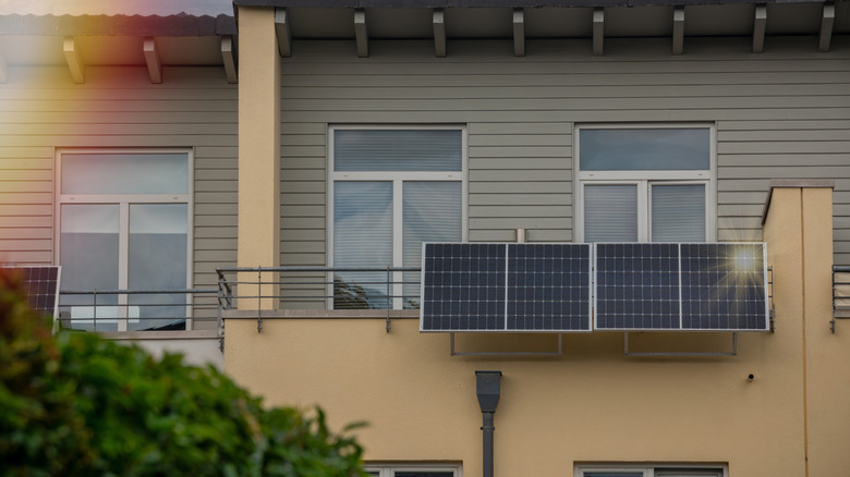 Solar panel setup on a balcony outdoors in an apartment complex.
