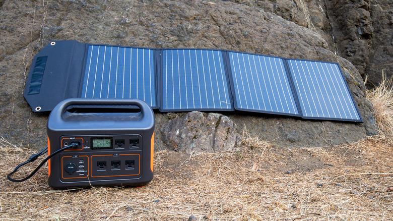 Jackery portable power station hooked to a solar panel out in the wild.