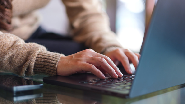 A person works on a laptop