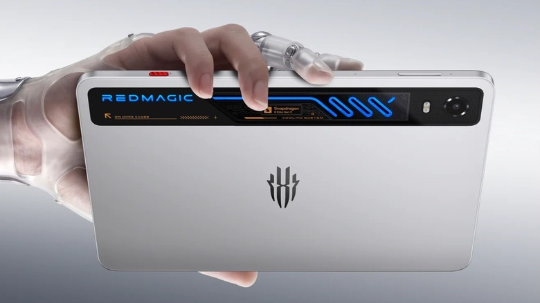 Robotic hand holding a RedMagic Astra 2 tablet