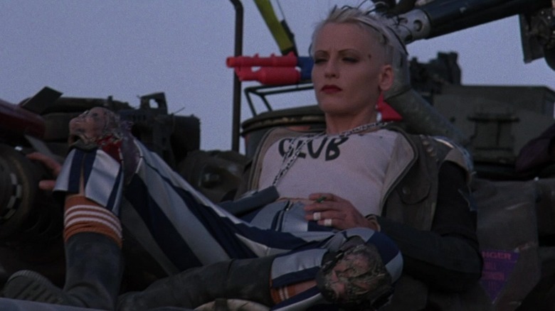 Lori Petty as Tank Girl sitting atop her tank