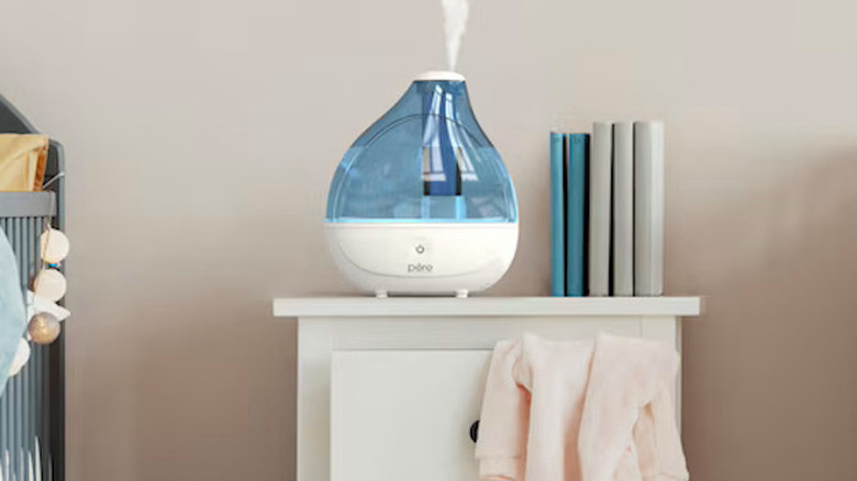 MistAire Tabletop Humidifier on a night table, shooting mist into the air