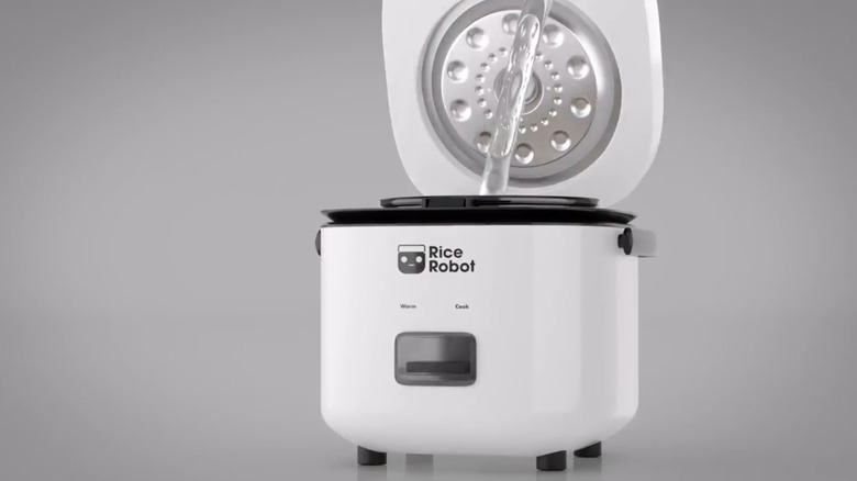 Rice Robot Cooker with water being poured into the central part