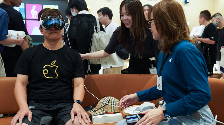 A person trying the Vision Pro in an Apple retail store.