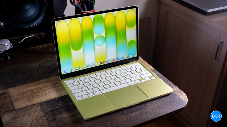 A Citrus MacBook Neo on a wooden table