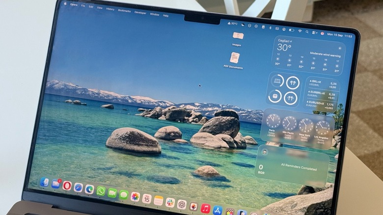 A close-up shot of a MacBook Pro running macOS Tahoe