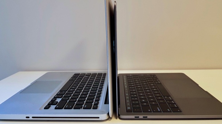 Two MacBook Pros side by side, one with a SuperDrive port