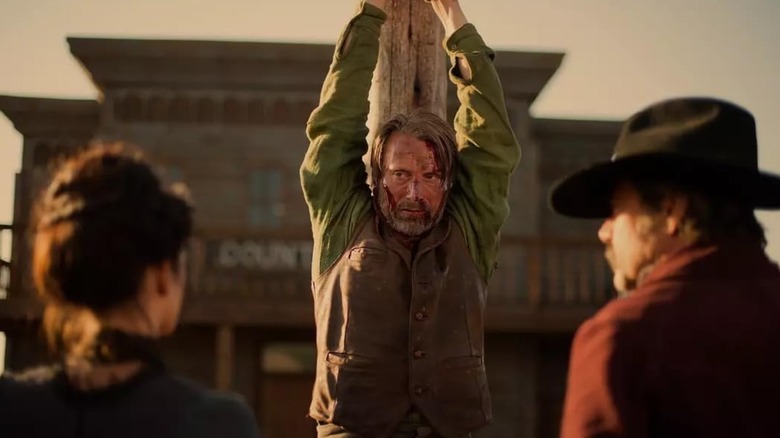 Mads Mikkelsen strung up by his wrists in The Salvation