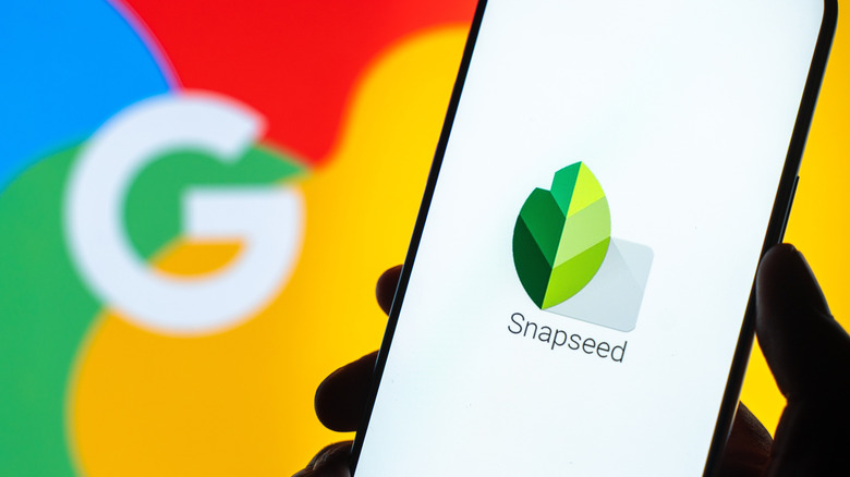 The Snapseed logo on a smartphone with the Google logo in the background
