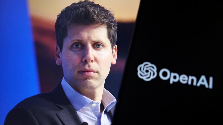 OpenAI CEO Sam Altman with a screen showing OpenAI logo behind him.