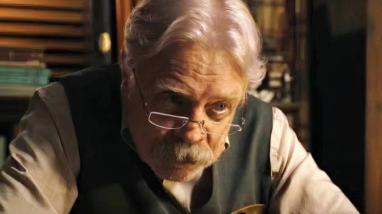 Mark Hamill as Albie Krantz leaning over in The Life of Chuck