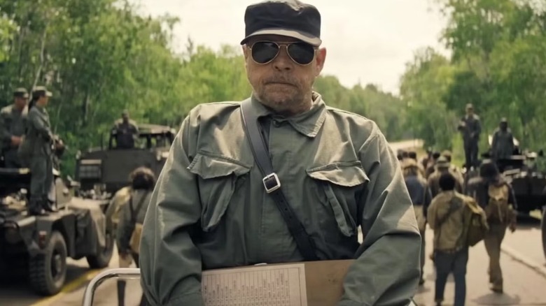 Mark Hamill as the Major stood in front of soldiers in The Long Walk
