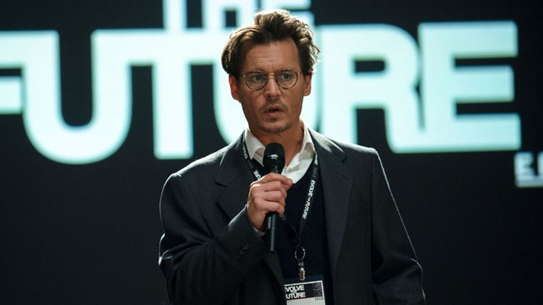 Dr. Will Caster giving a speech with a microphone in his hand