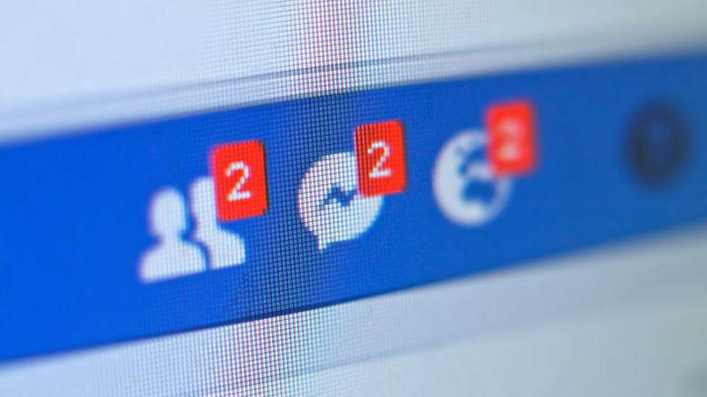 closeup of facebook friend and messenger icon on a monitor