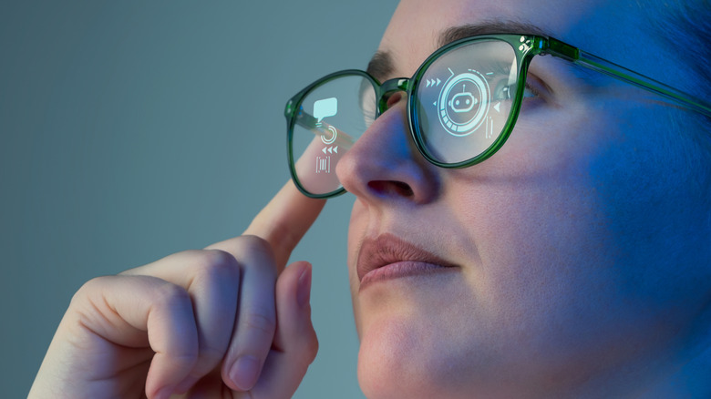 A woman wearing smart glasses that show icons inside the lenses