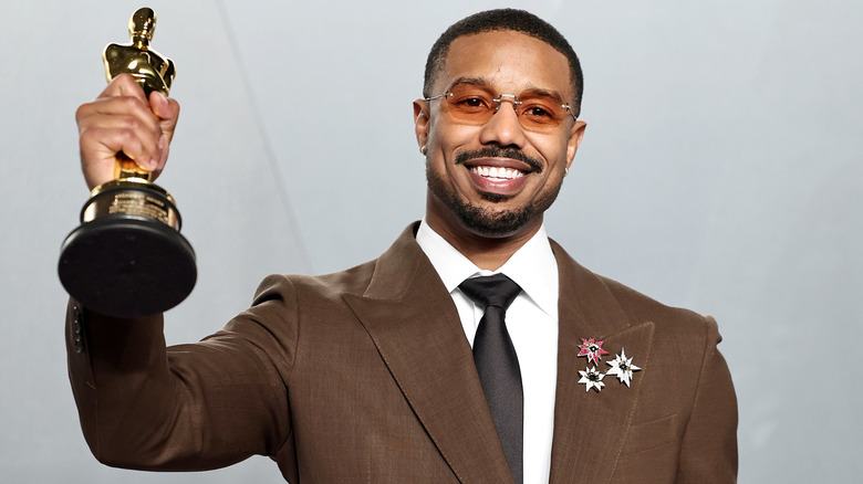 Michael B. Jordan holding his Oscar award