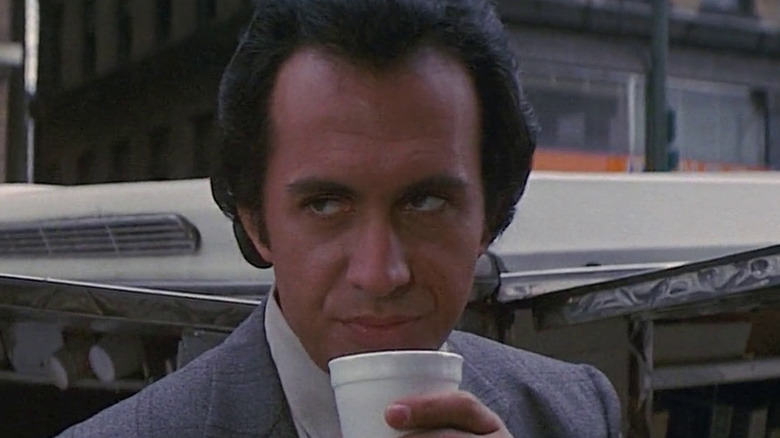 Charles (Gene Simmons) holding a coffee cup in "Runaway."