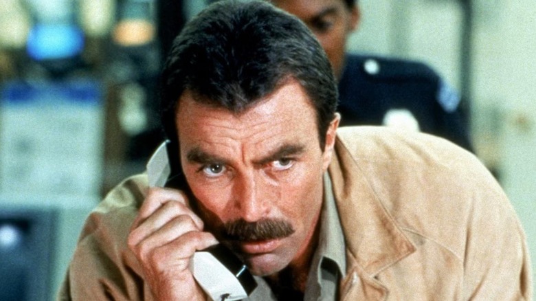 Jack (Tom Selleck) holding a phone in 