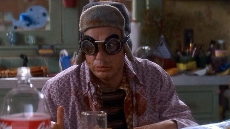 Lenny wearing goggles and a hat while eating