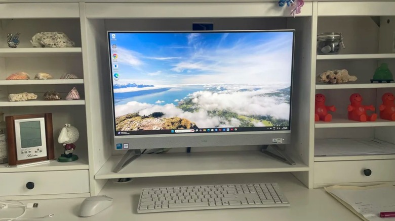 A user-submitted photo of the Dell 27 EC27250 27-inch All-in-One Desktop Computer, the computer sits inside a a cupboard on a desk