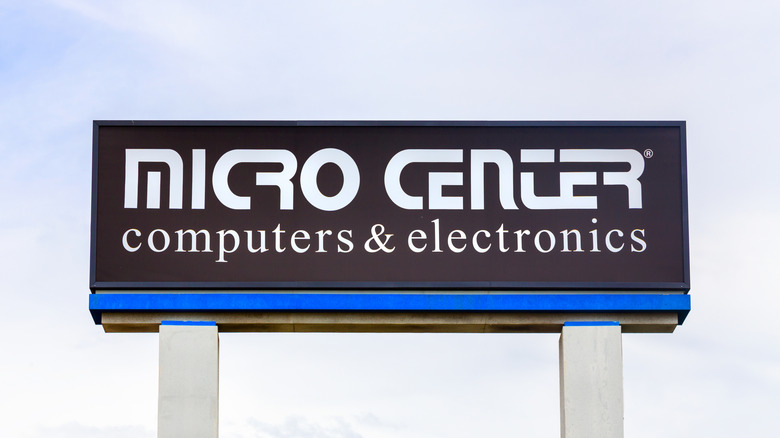 A closeup of an outdoor Micro Center sign, the logo is a white font against a black background