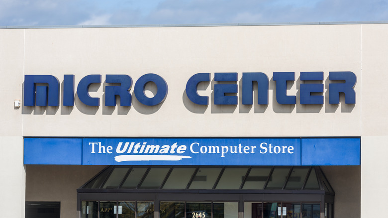 An exterior shot of a Micro Center building which prominently displays the Micro Center logo and slogan