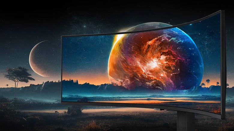 A photo of the Samsung Odyssey G9 1440p 49-inch Curved Screen Monitor, the monitor is displaying a large orange and blue planet that also takes up the background